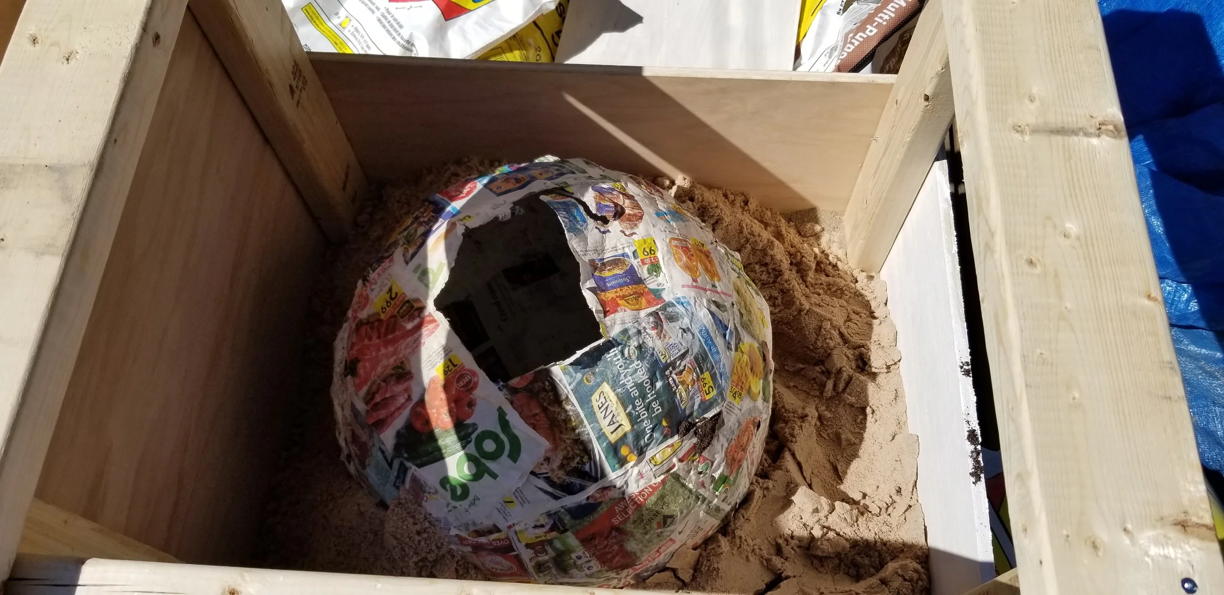 Cover about a quarter of the stone mold with sand before starting to fill with cement.